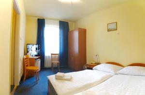 Posteľ alebo postele v izbe v ubytovaní Corvin Hotel
