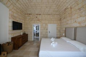 Postel nebo postele na pokoji v ubytování Palazzo Momi