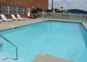 a large blue swimming pool in front of a building at Comfort Inn & Suites Raphine - Lexington near I-81 and I-64 in Raphine