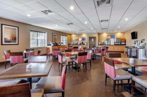 a dining room with tables and chairs in a restaurant at Comfort Inn & Suites Raphine - Lexington near I-81 and I-64 in Raphine
