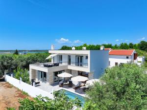 an aerial view of a house with a swimming pool at CROWONDER Villa Bura with Heated Swimming Pool and Jacuzzi in Privlaka
