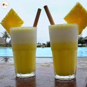 two glasses of orange juice sitting on a table at Lime Tree Luxurious 3BHK Serviced Apartment Near Medanta in Gurgaon