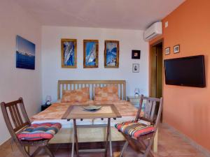 a bedroom with a bed and a table and chairs at Appartement Melchior - Turm Krk in Sveti Vid-Miholjice