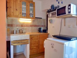 a small kitchen with a sink and a refrigerator at Appartement Melchior - Turm Krk in Sveti Vid-Miholjice