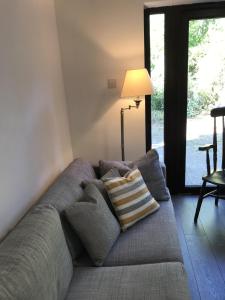 a couch with a pillow on it in a living room at Amazing Cambridge house in Chesterton