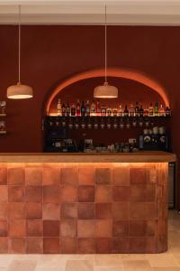 a bar with bottles of alcohol on a wall at Hotel Rural Sant Ignasi in Ciutadella