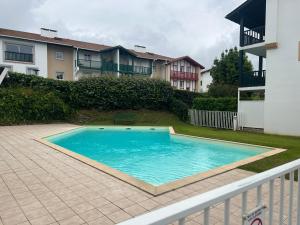 a swimming pool in the yard of a house at APT Subernoa in Hendaye