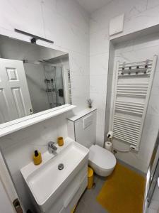a white bathroom with a sink and a toilet at Apartment sea Lux in Povljana +36 photos