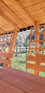 a wooden pergola with a view of a field at Camping Pentru Rulote, Auto Rulote, Corturi Personale La Barbosu in Lepsa, Vrancea in Lepşa