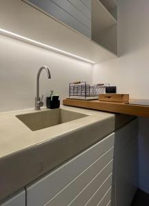 a kitchen with a sink and a counter at Hideaway Syros in Megas Gialos - Nites +21 photos