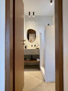 a bathroom with a sink and a mirror at Hideaway Syros in Megas Gialos - Nites