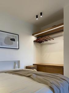 a bedroom with a bed and a picture on the wall at Hideaway Syros in Megas Gialos - Nites