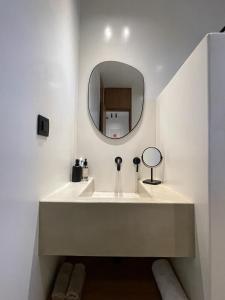 a bathroom with a sink and a mirror at Hideaway Syros in Megas Gialos - Nites