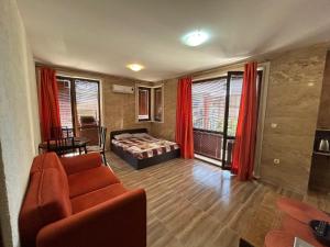 a living room with a couch and a bed at Apartments Amara Sunny Beach in Sunny Beach +197 photos