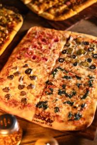 a group of pizzas sitting on top of a table at Marasa Sarovar Portico -Rajkot in Rajkot