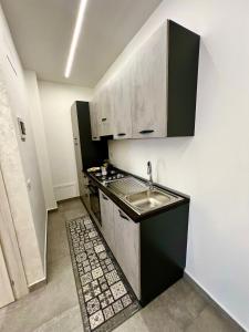 a small kitchen with a sink and a stove at Flowers Apartments in Marineo