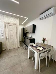 a kitchen with a table with two plates on it at Flowers Apartments in Marineo
