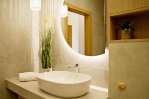 a bathroom with a white sink and a mirror at Magic Apartments - Siena in Zator +40 photos
