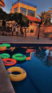 a swimming pool with several inflatable boats in the water at شاليهات ومسابح مزارع in Al Azraq ash Shamālī