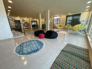a living room with colorful chairs and a lobby at شاليهات ومسابح مزارع in Al Azraq ash Shamālī