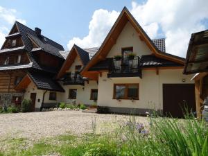 a house with black roof at Apartamenty Tatrzańska Dolina in Kościelisko
