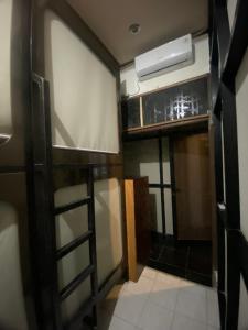 a view of a room with a door and a fan at skyz hostel in Padang