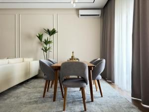 a dining room with a table and chairs at Family Suite for 4 - 6 people! Direct access to Tashkent CITY MALL, Central Park, Hilton Hotel, Chorsu Bazaar! in Tashkent