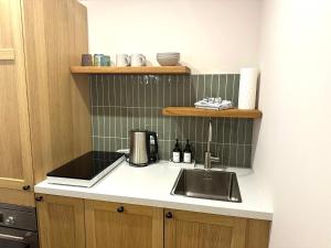 a kitchen with a sink and a counter top at Yutori - Apartment in Malchow