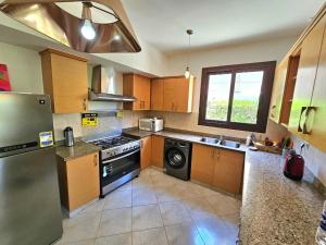 a kitchen with a stove and a dishwasher at Twinhouse for rent in Marassi in El Alamein +16 photos