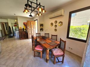 a dining room with a wooden table and chairs at Twinhouse for rent in Marassi in El Alamein