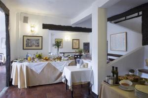 a dining room with two tables with white table cloth at Posada San José in Cuenca