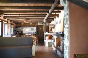 a living room with a couch and a stone fireplace at Agriturismo Volpignano in Collesano
