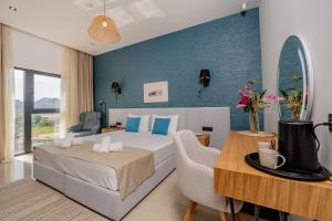 a hotel room with a bed and a table at Hotel AQUILO in Petrovac na Moru