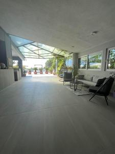 a large living room with a couch and chairs at Dela in Hvar