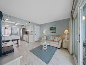 a living room with a couch and a table at Beach Bliss condo in Carolina Beach