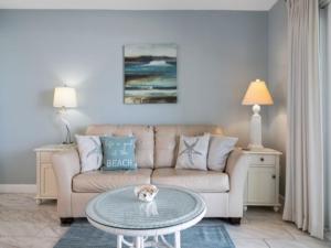 a living room with a couch and a table at Beach Bliss condo in Carolina Beach
