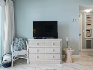 a white dresser with a television on top of it at Beach Bliss condo in Carolina Beach +20 photos