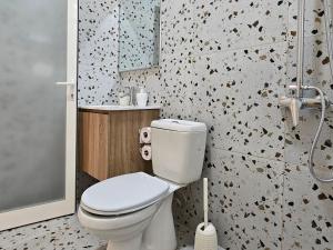 a bathroom with a white toilet and a shower at Lemon House Borsh in Himare +40 photos