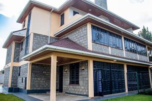 a large house with a large front door at Kathy's Serene Suites in Nairobi