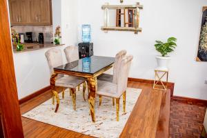 a dining room with a table and chairs at Kathy's Serene Suites in Nairobi
