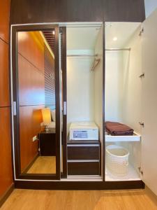 a walk in closet with a glass door at Hotel De Wualai in Chiang Mai