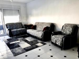 a living room with two chairs and a couch at Kame House in Gandía +18 photos