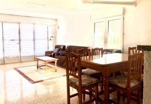 a living room with a table and chairs and a couch at Kame House in Gandía