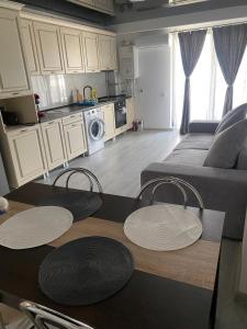 a living room with a couch and a table and chairs at Sun up mamaia nord 2 in Năvodari