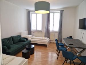 a living room with a couch and a table at City Apart Hannover in Hannover