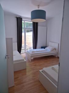 a room with two beds and a large window at City Apart Hannover in Hannover +1 photo