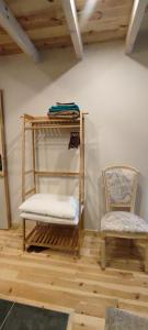 a room with a chair and a shelf and a chair at Le Mazel in Saint-Agrève