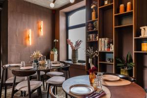 a restaurant with tables and chairs and a window at Gare 55 in Evergem +41 photos