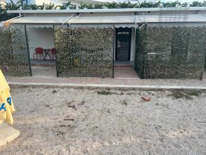 a building with a wall covered in vines at Relax Stay in Ksamil +3 photos