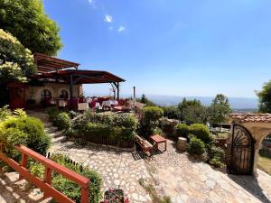 a patio with a table and chairs in a garden at Rooms Merlika -Inside the Castle- in Krujë +48 photos